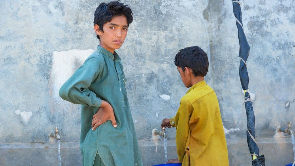 Children using a community water point in Khyber Pakhtunkhwa