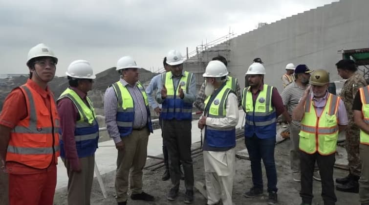 People reviewing construction work at the Mohmand Dam site